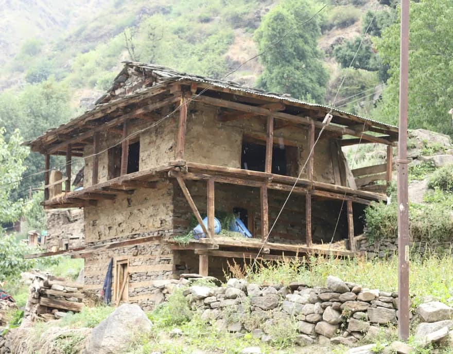 A traditional stone and timber house on a hillside near Khir Ganga